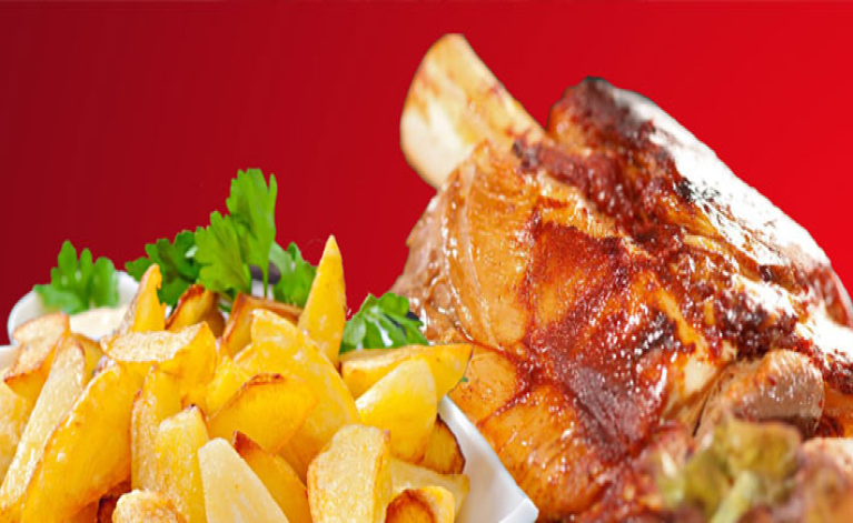 Stinco di maiale con patate al forno